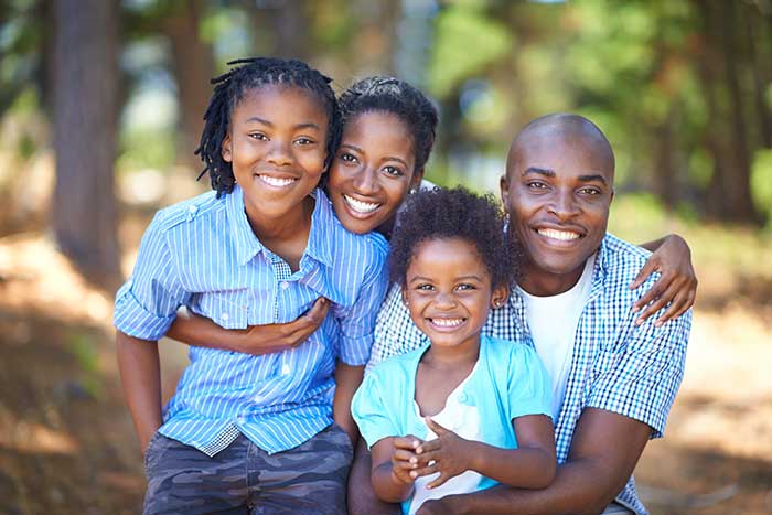 Happy Family spending time out in park together.